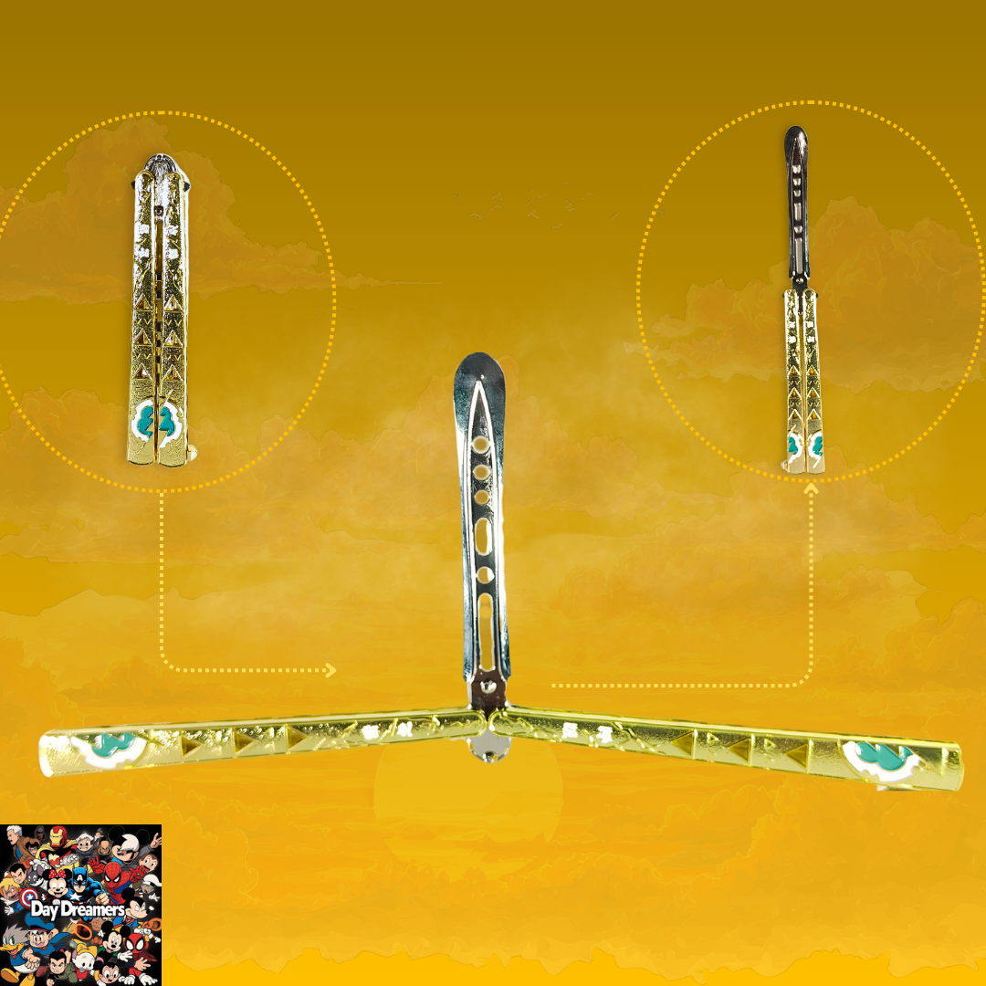 Gold-tone metal butterfly balisong trainer with engraved decorative pattern