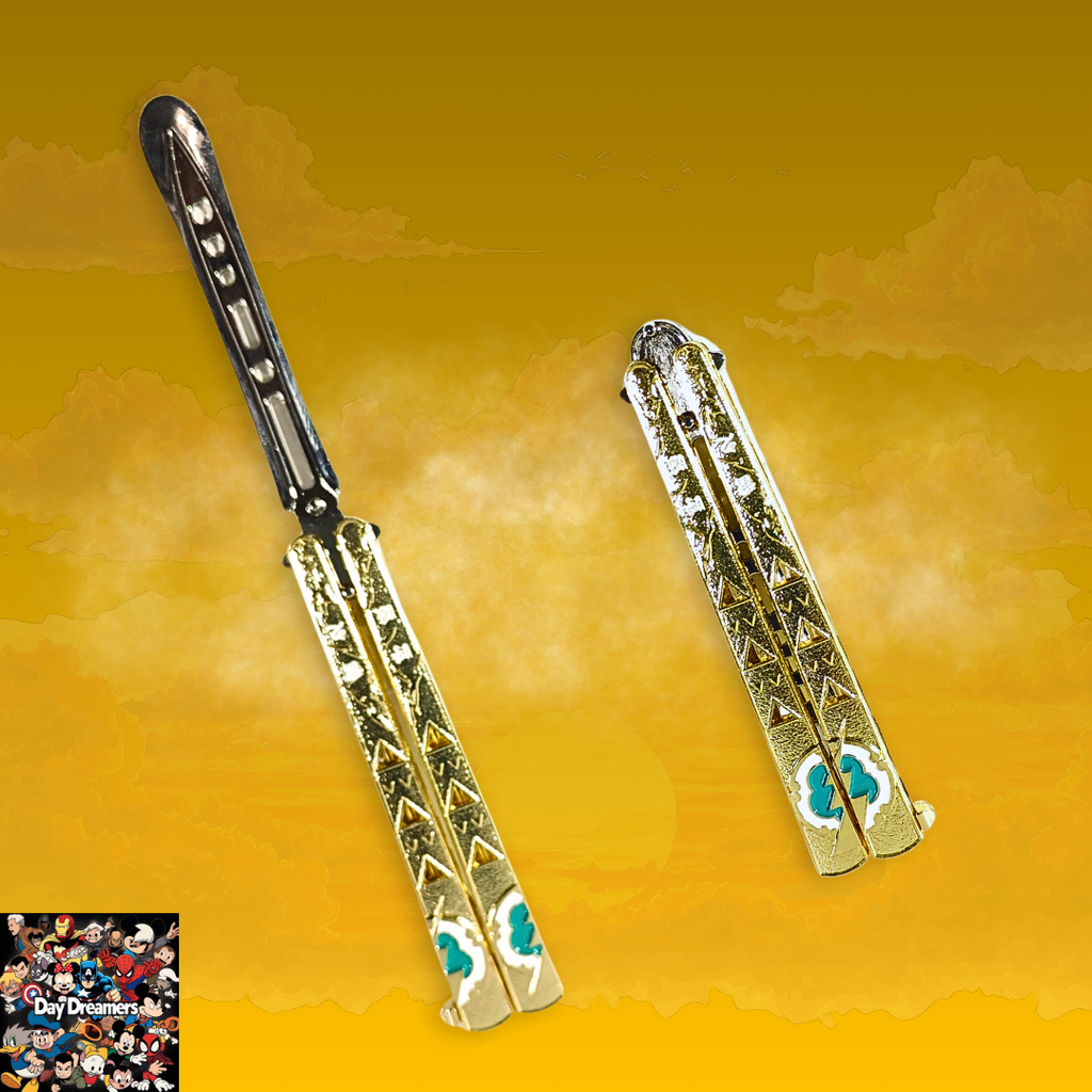 Gold-tone metal butterfly balisong trainer with engraved decorative pattern